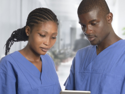 man and woman nurse aides checking notes