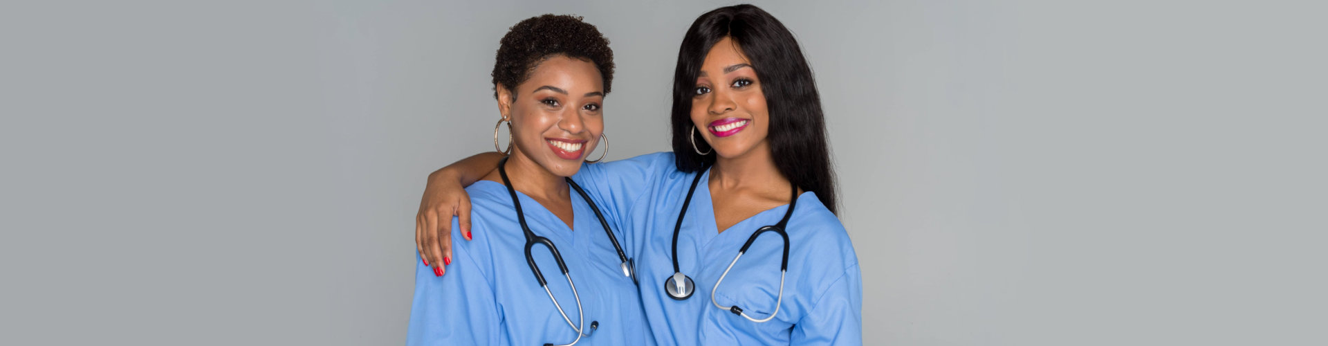 two female nurses smiling