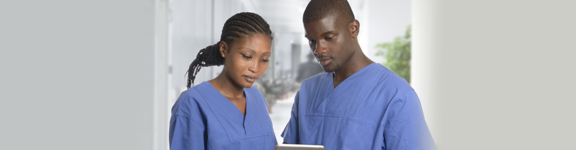 man and woman nurse aides checking notes